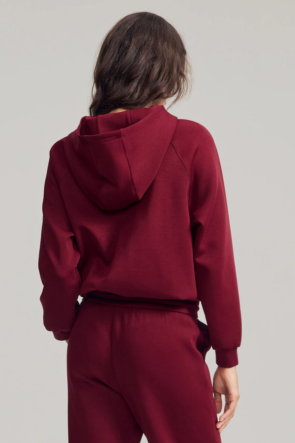 Back view of women’s burgundy wine fleece hoodie with clean, minimal shape