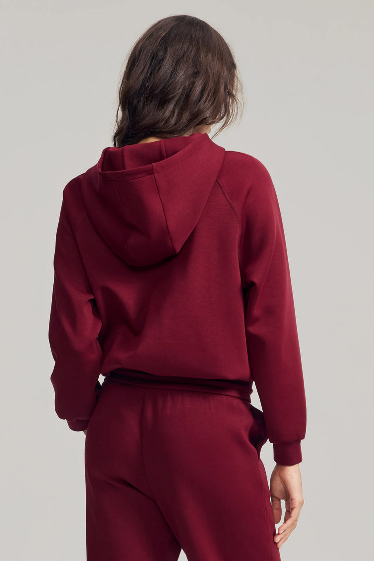 Back view of women’s burgundy wine fleece hoodie with clean, minimal shape