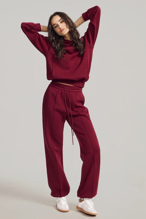 Women’s burgundy wine hoodie styled with matching sweatpants for a refined lounge look