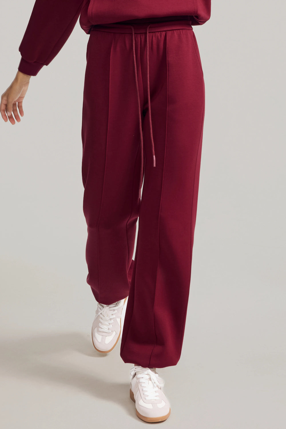 Luxe fleece jogger in Burgundy Wine styled with a matching sweatshirt, front view on grey background
