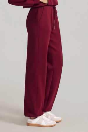 Side view of Burgundy Wine wool-blend joggers with a relaxed, straight-leg silhouette