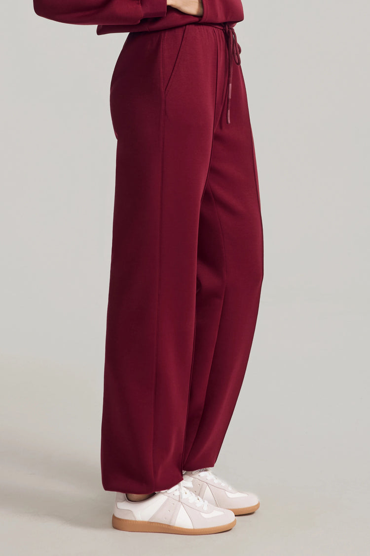 Side view of Burgundy Wine wool-blend joggers with a relaxed, straight-leg silhouette
