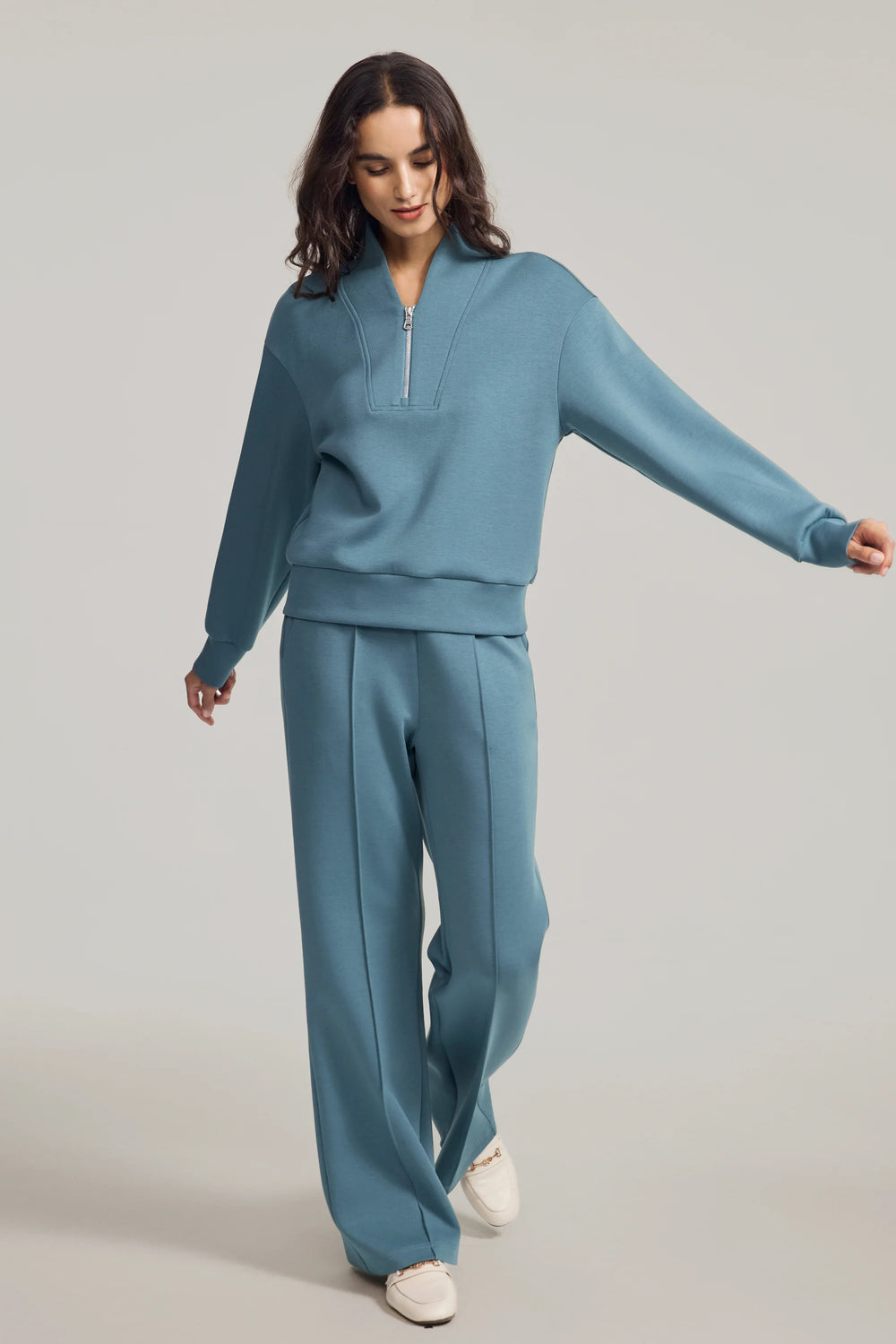 Luxe half-zip pullover in Slate Blue styled with matching trousers, front view on grey background