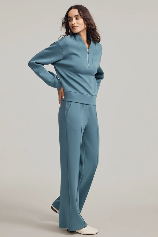 Slate Blue half-zip pullover shown from the side, emphasizing soft drape and relaxed ease