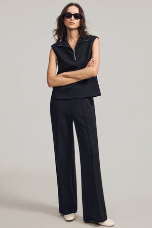 Front view of a modern sleeveless zip-collar pullover emphasizing a high neckline and refined shape