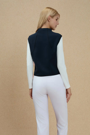 Back view of a sculpted sleeveless knit top showing a clean, streamlined silhouette