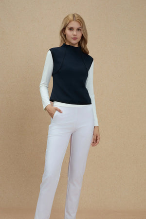 Front view of a sculpted knit sleeveless top layered for structured comfort and ease