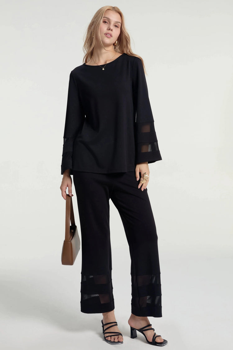 Sheer panel crepe set styled with a handbag against a grey background, front view