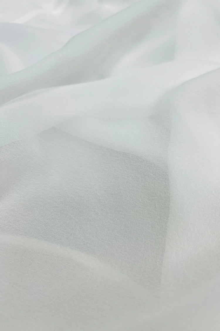 Close-up of sheer silk chiffon fabric showing airy texture and soft translucency