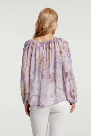 Sheer silk chiffon blouse shown from the back, highlighting fluid drape and softness
