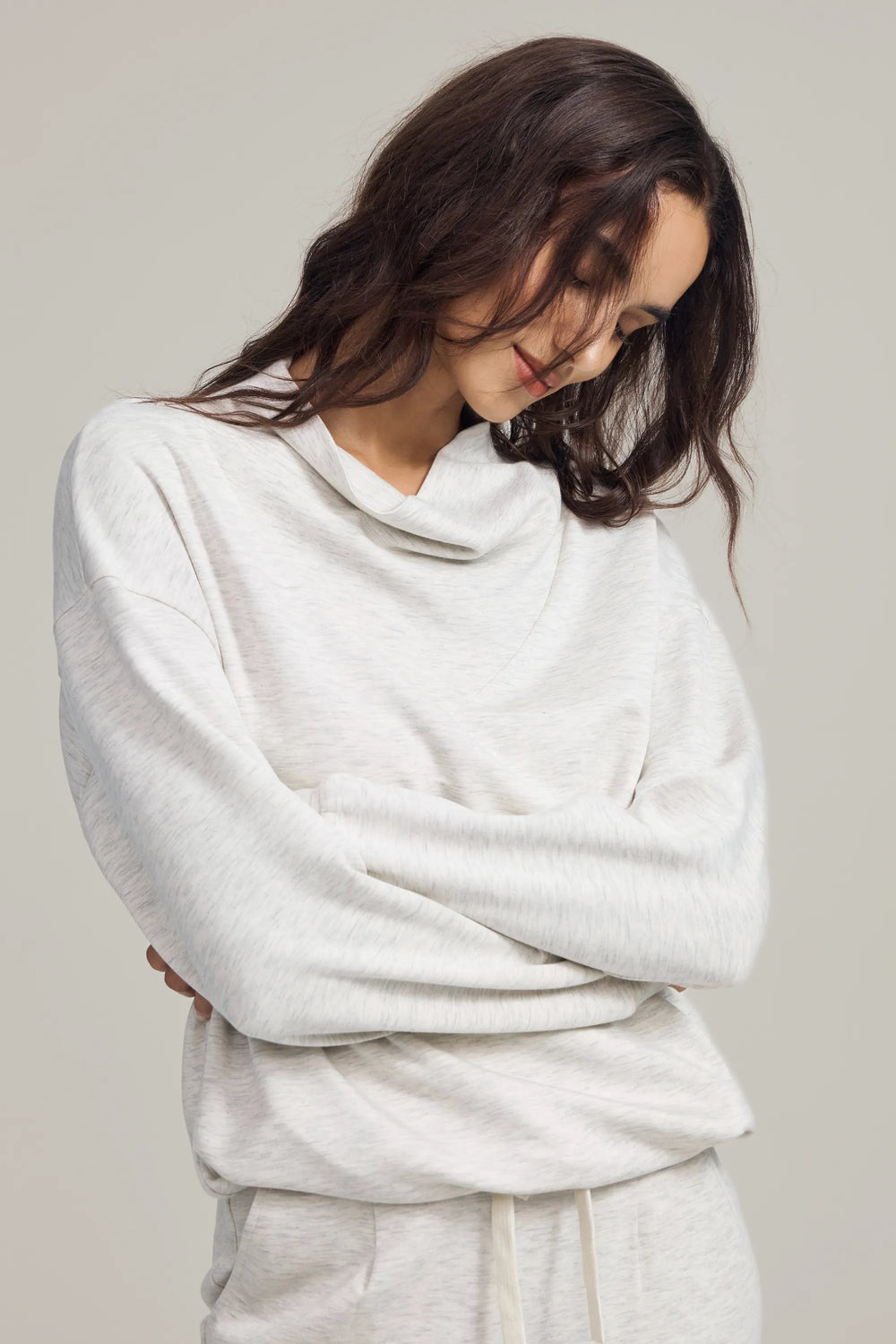Soft drape funnel-neck pullover in heather oatmilk, front view on grey background