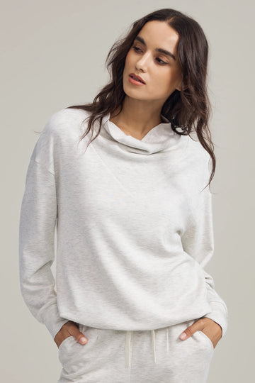 Soft drape funnel-neck pullover in heather oatmilk, front view on grey background