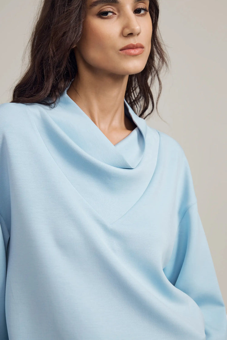 Close-up of the Tencel™ cowl neckline showing a soft, fluid drape
