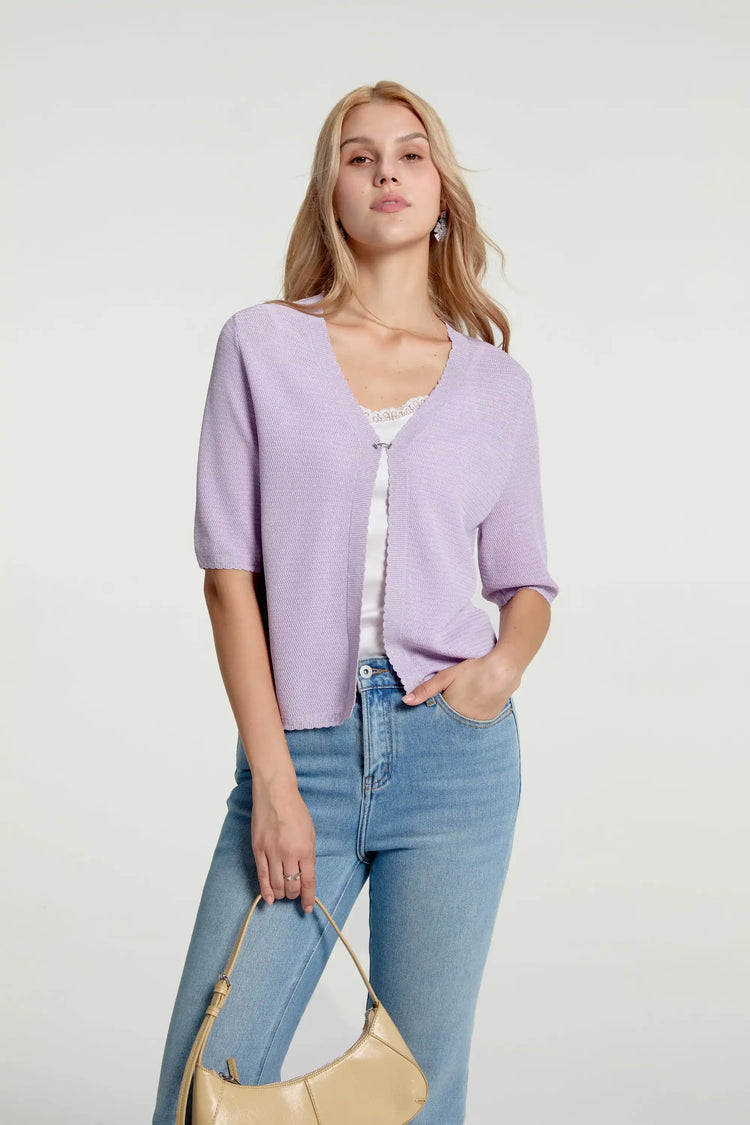 Women’s soft knit hook-front cardigan styled with blue jeans and a handbag, upper-body front view