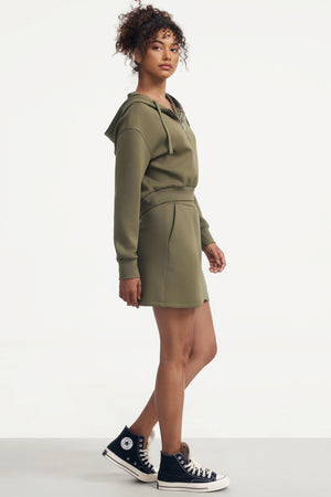 Emara soft moss fleece skirt styled with a matching hoodie for a coordinated, relaxed everyday look.