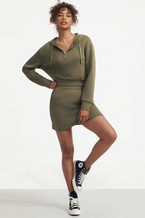 Soft moss wrap-front fleece skirt paired with a matching hoodie, creating a clean and effortless casual outfit.