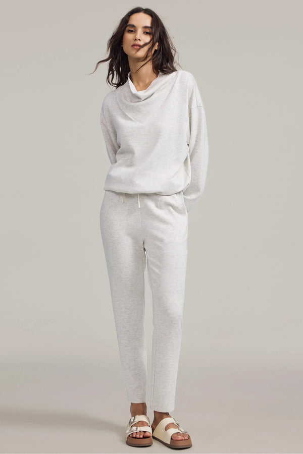 Soft tapered lounge pants in heather oatmilk styled with a matching pullover, front view