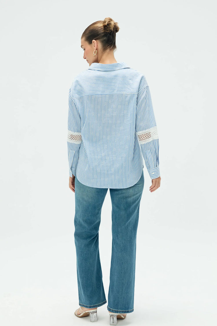 Back view of women’s striped popover blouse with clean lines and easy shape