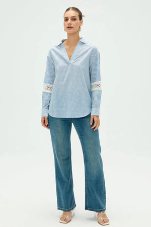 Women’s striped popover blouse styled for a clean, polished full-body look