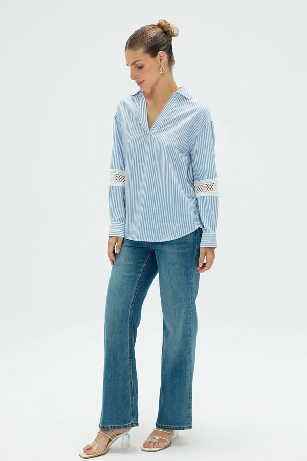 Side view of women’s striped popover blouse showing fluid drape and relaxed silhouette
