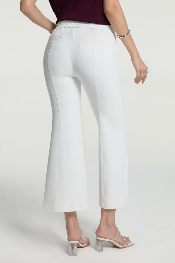 Back view of cream white kick-flare trousers featuring a clean, refined fit