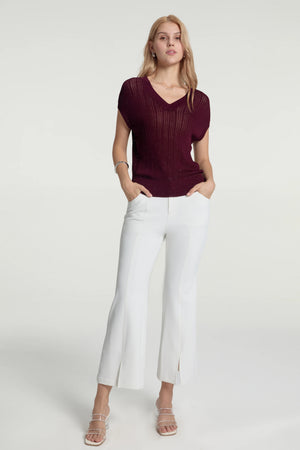 Tailored kick-flare trousers styled with a rust short-sleeve top for an elevated look