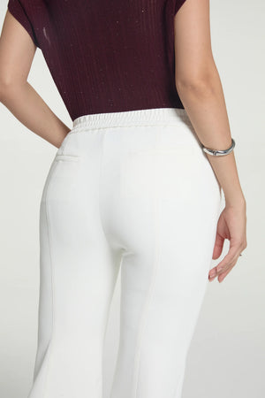 Detail view highlighting the sculpted seat and smooth tailoring of kick-flare trousers