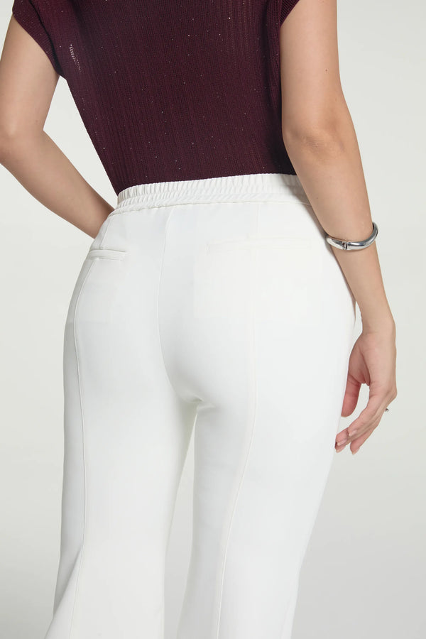 Detail view highlighting the sculpted seat and smooth tailoring of kick-flare trousers