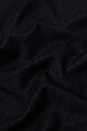 Close-up of soft stretch denim fabric showing refined texture and structure