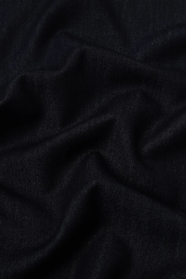 Close-up of soft stretch denim fabric showing refined texture and structure