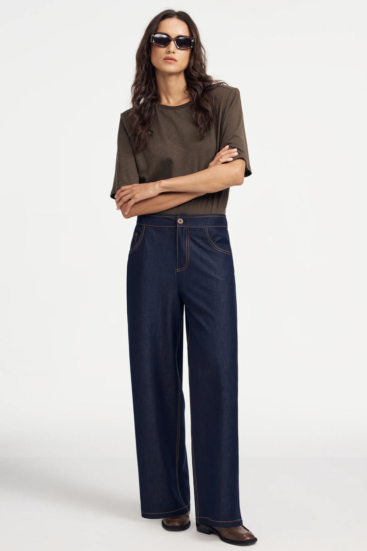 Tailored wide-leg denim in ink rinse styled with a brown tee for a refined, modern look