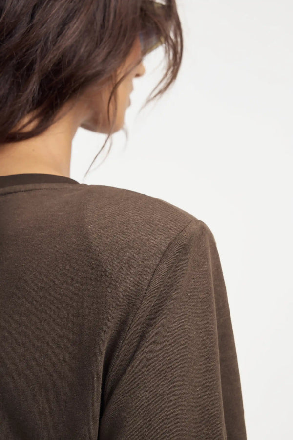 Close-up of espresso brown T-shirt bodysuit showing padded shoulders and Linen–Supima fabric