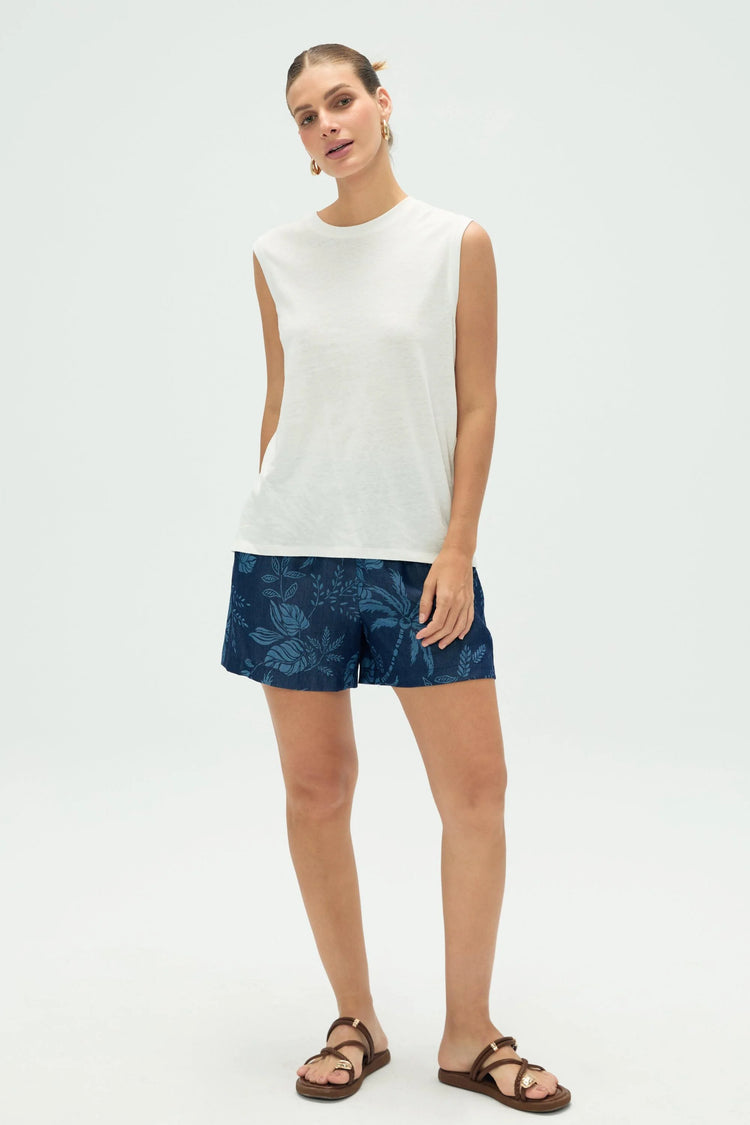 Women’s indigo palm tropical pull-on shorts styled with a white tank, full-body front view