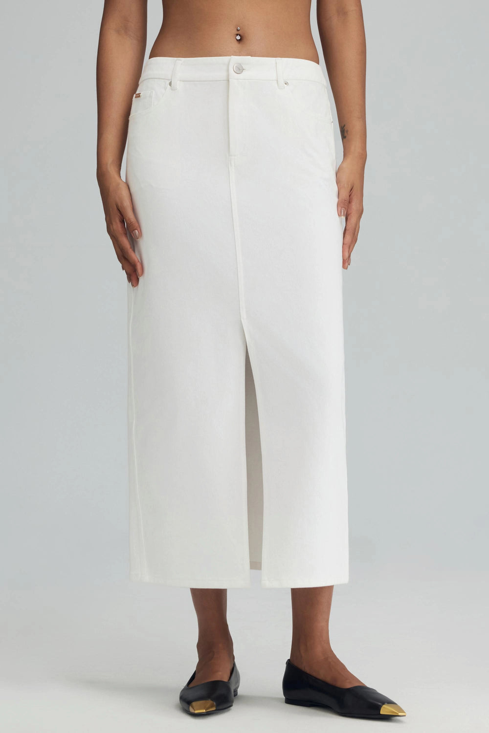 White stretch denim straight maxi skirt in classic white, shown from the side with clean lines and a tailored fit.