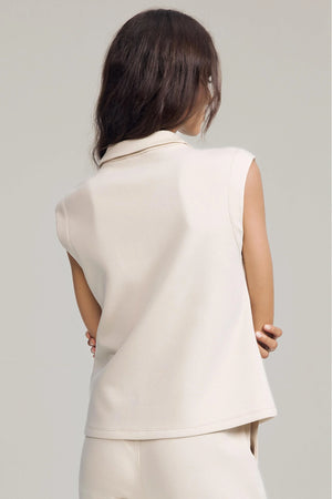 Back view of a sleeveless zip-collar pullover with a streamlined, modern fit