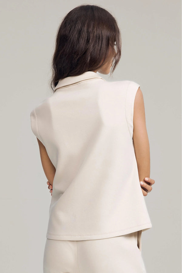 Back view of a sleeveless zip-collar pullover with a streamlined, modern fit