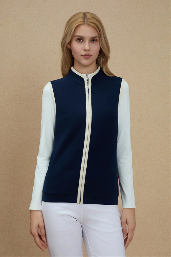 Zip-front vest in Midnight Navy layered over a white long-sleeve top, front view