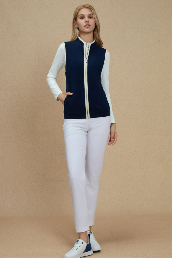 Navy zip-front vest styled with white athletic trousers for a clean, modern look