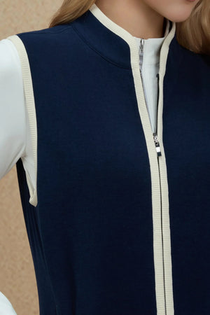 Close-up of the zip-front detail on a viscose–silk blend vest with contrast trim