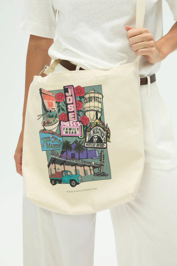 Everyday canvas tote with San Jose postcard print worn crossbody, front view