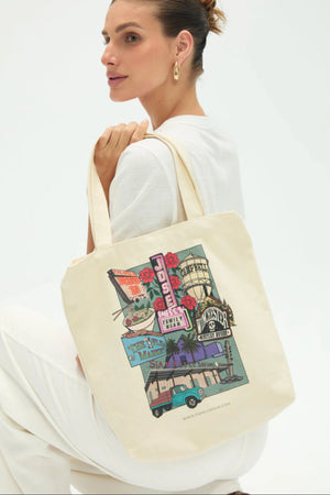 Handheld everyday canvas tote with San Jose print shown in a relaxed lifestyle pose