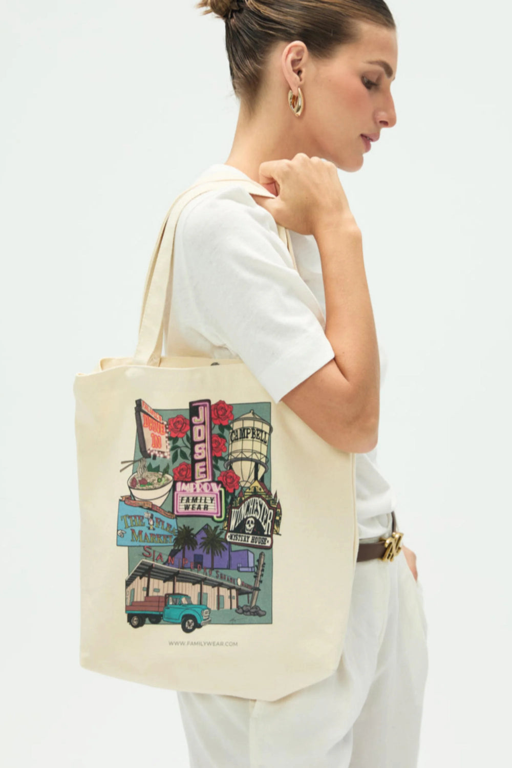 Everyday canvas tote with San Jose postcard print worn crossbody, front view