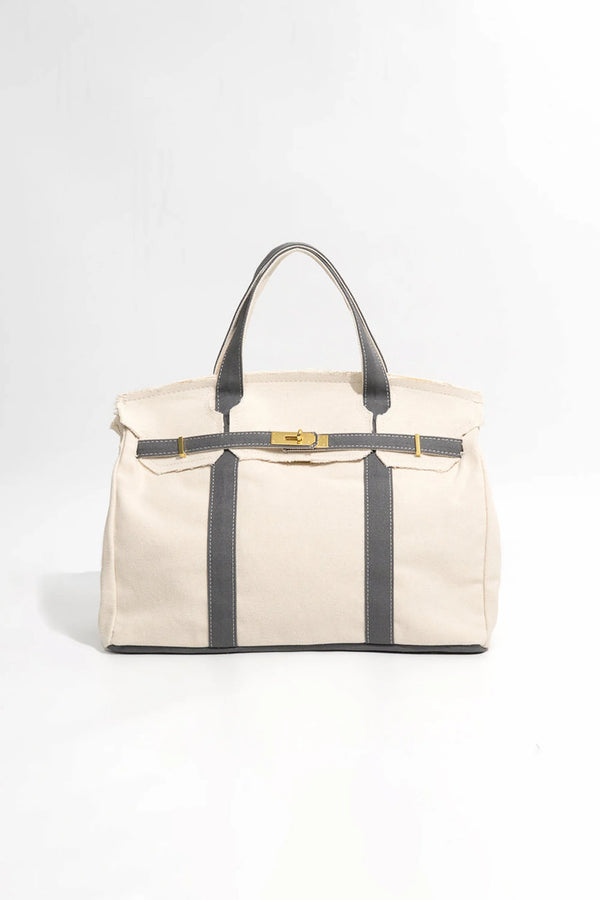 Handmade canvas tote in blue-grey with reinforced handles and steel hardware