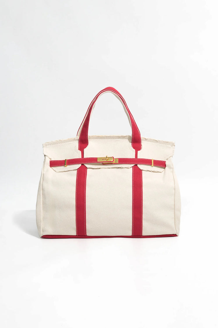 Handcrafted canvas tote in red featuring a durable cotton construction, front view