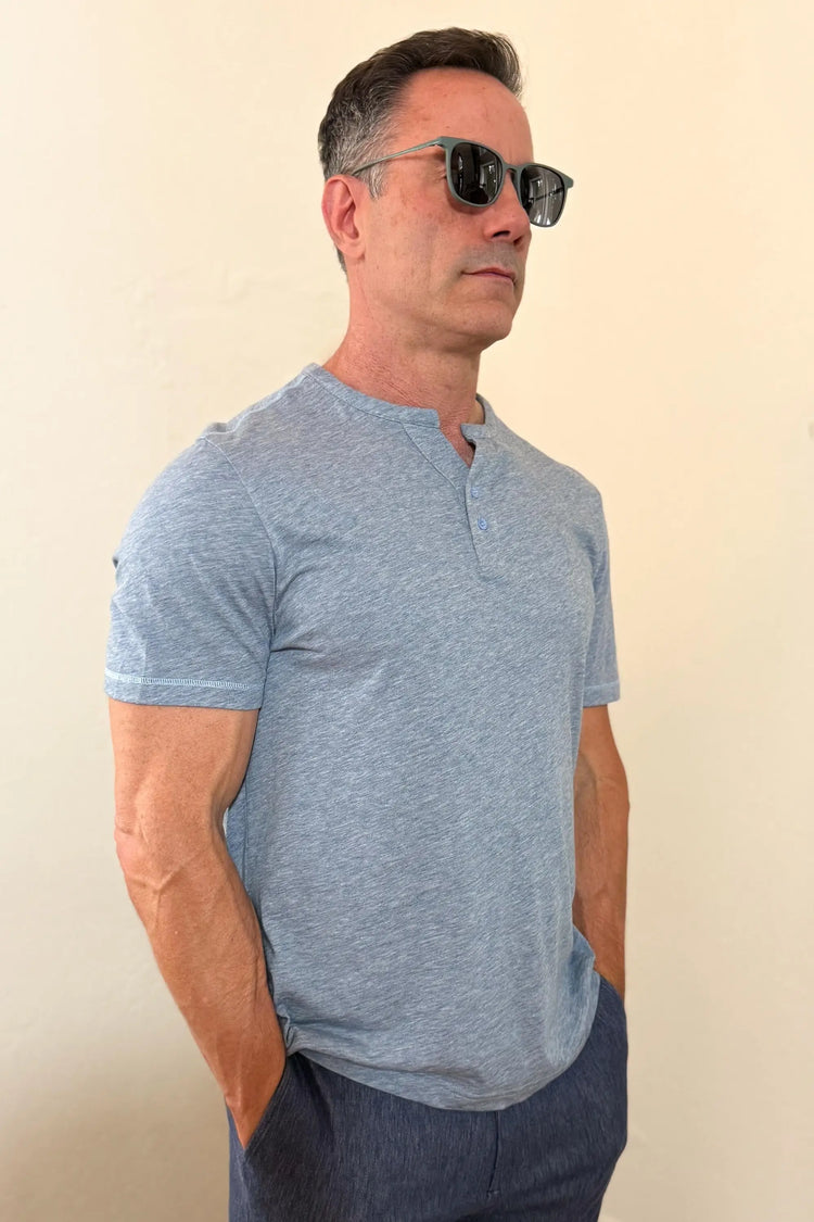 Side view of a men’s steel blue cotton–Tencel henley tee, highlighting the modern fit and clean silhouette.