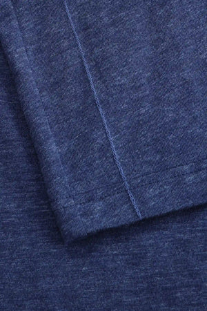 Detail of the hem finish on a men’s maritime blue cotton-Tencel long-sleeve polo.