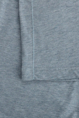 Detail of the hem finish on a men’s steel blue cotton-Tencel open-collar polo