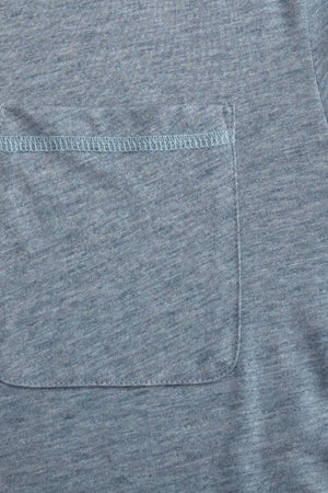 Close-up of the relaxed open-collar pocket on a men’s steel blue cotton-Tencel polo.