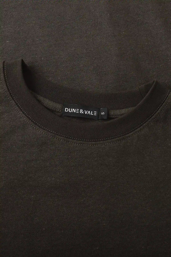 Close-up of the crewneck collar on a men’s espresso linen–Supima tee.
