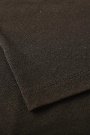 Detail of the hem finish on a men’s espresso linen–Supima crewneck tee.